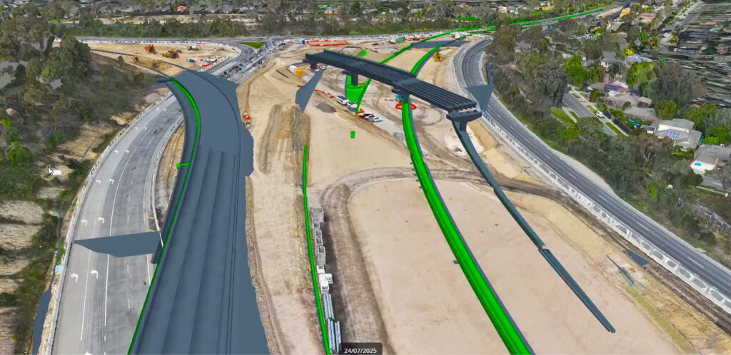A digital model of a complex highway interchange superimposed on the actual construction site, illustrating a 4D construction sequencing plan.