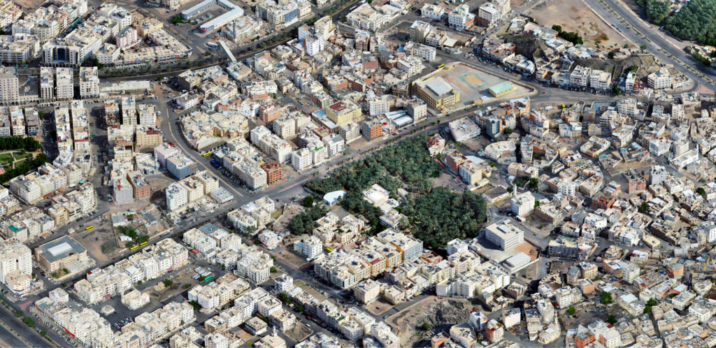 An aerial reality model of a dense urban environment, showcasing the application of geospatial and reality modeling for infrastructure projects.