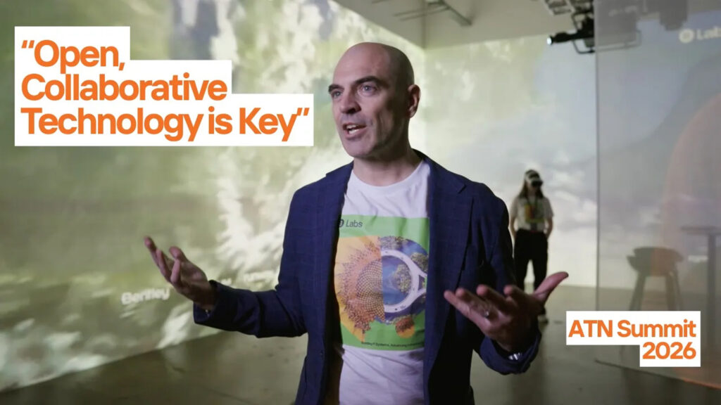 Speaker at a summit discussing open, collaborative technology; orange text overlay reads 'Open, Collaborative Technology is Key' (ATN Summit 2026).