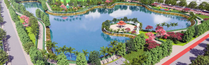Aerial view of Atal Puram Township’s landscaped park featuring a large pond, central pavilion, walking paths, trees, and flowerbeds as part of the township's detailed design masterplan.