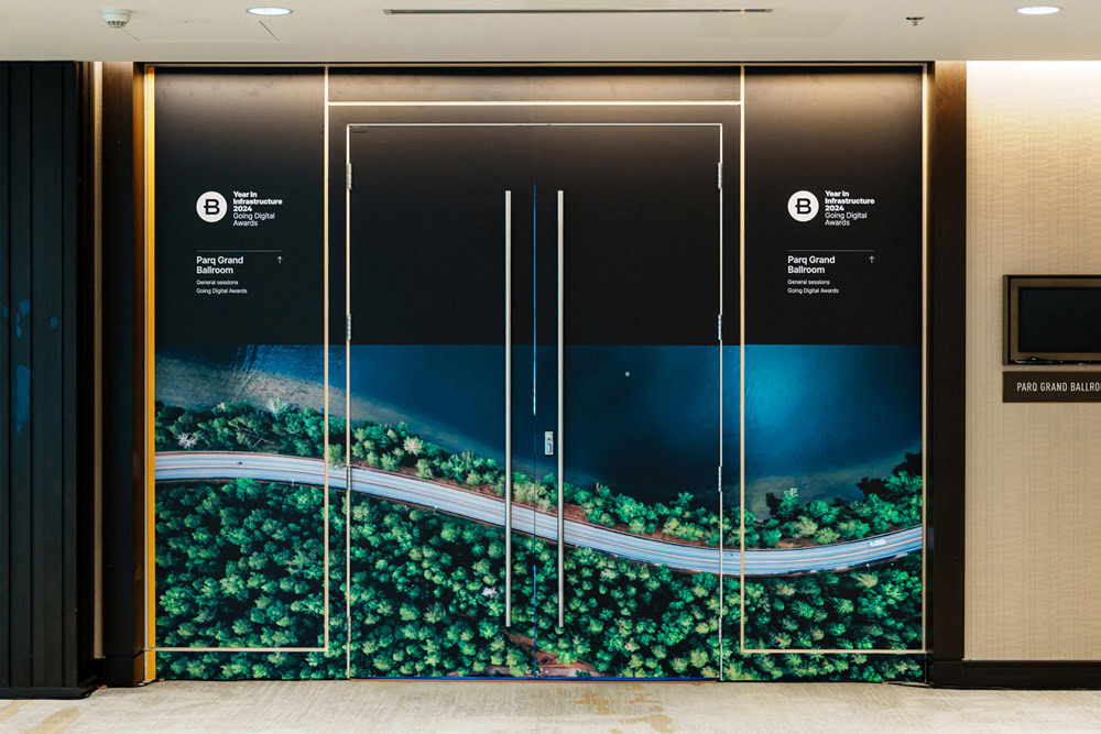 Large double doors feature printed artwork of a winding road along a forested shoreline, leading to the "Para Grand Ballroom" as indicated by signage on the left.