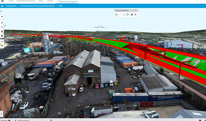 A digital rendering shows an industrial area with warehouses and vehicles, overlaid by a 3D model of the Transpennine Route Upgrade (TRU) railway project highlighted in red and green.