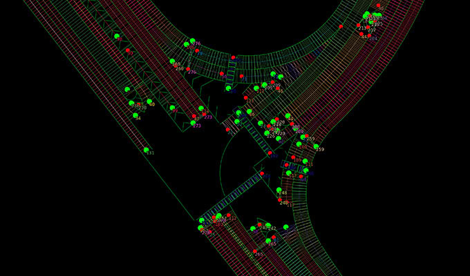 A digital architectural or engineering diagram showing a road intersection with various colored markers, grids, and annotations on a black background.