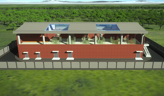 A computer-generated rendering of a rectangular building with a flat roof, several skylights, and loading docks, surrounded by a fence and greenery in Qinghai Province’s Guoluo Tibetan Autonomous Prefecture.