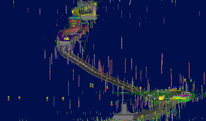 A computer-generated 3D model illustrating the North East Link Central Package, featuring a winding road or track with colored markers and structures, set against a dark blue background.