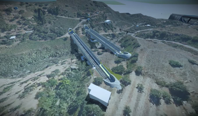 Aerial view of two parallel elevated railway bridges under construction through a hilly, rural landscape, showcasing innovation and digital construction site technology amidst sparse vegetation and a few buildings.