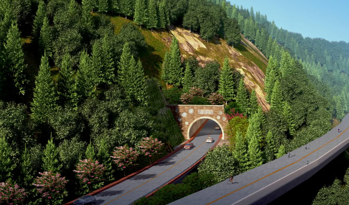 A road tunnel passes through a forested hillside on the Ecological Highway, with cars entering and exiting; a parallel elevated road runs nearby, bordered by dense green trees.