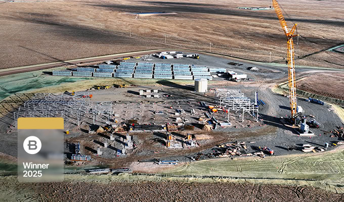 Aerial view of a power transmission and transformation site by China Southern Power Grid, featuring steel frame structures, cranes, and vehicles on barren land; a "Winner 2025" badge and GIS+BIM digital intelligence highlight innovation.