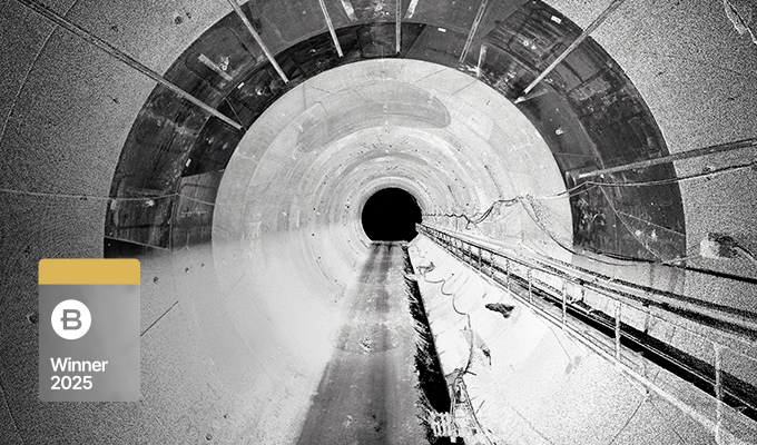 Black and white photo of a large, empty tunnel with cables along the right wall, highlighting a power transmission and transformation project by China Southern Power Grid; a "Winner 2025" badge appears in the lower left corner.